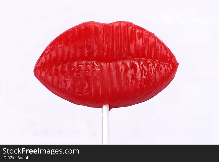 Red lips candy lollipop on white background