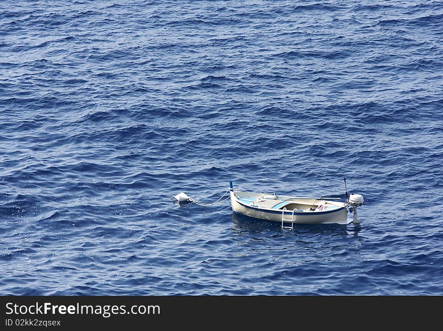 A small fishing boat at anchor in the mediterranean