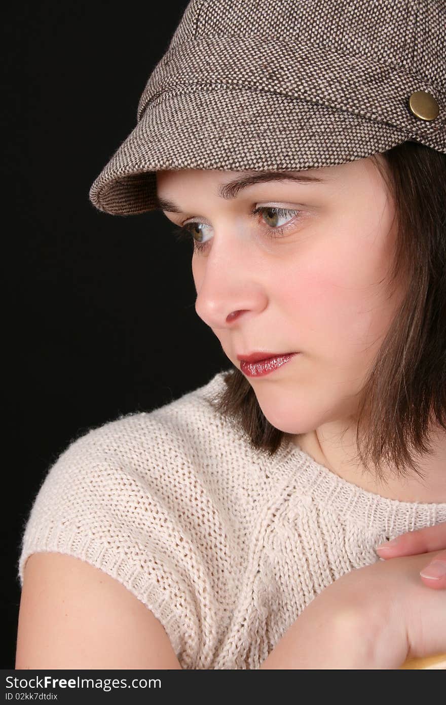 Beautiful brunette with a cute hat on black background. Beautiful brunette with a cute hat on black background