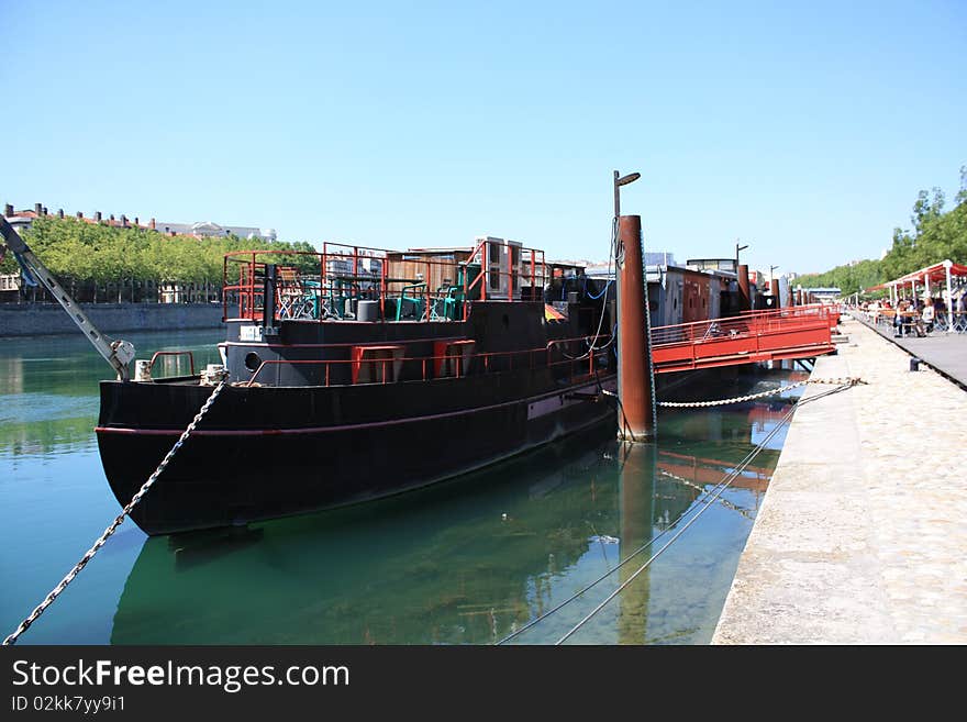 Barge moored on the dock Saone - Lyon, France