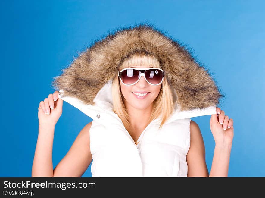 Beautiful woman wearing glasses on a blue background. Beautiful woman wearing glasses on a blue background