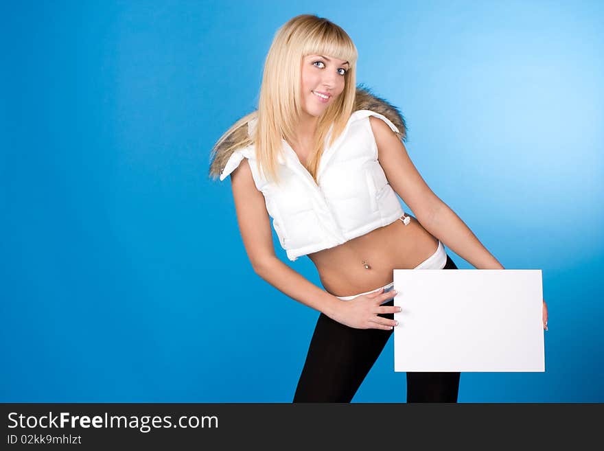 Closeup portrait of cute young woman holding a white page on a blue background. Closeup portrait of cute young woman holding a white page on a blue background