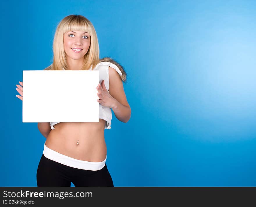 Closeup portrait of cute young woman holding a white page on a blue background. Closeup portrait of cute young woman holding a white page on a blue background