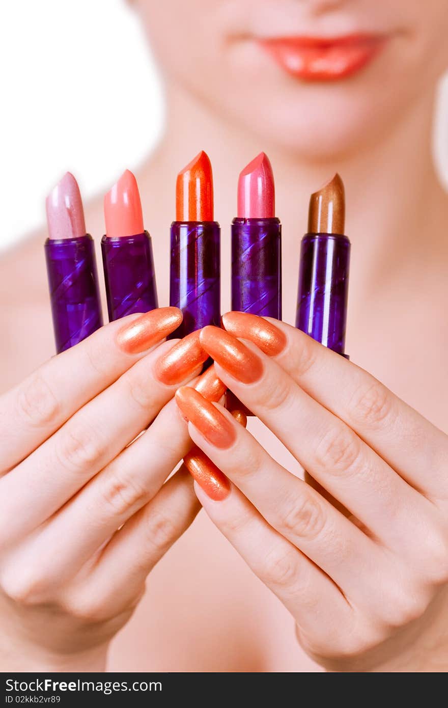 Girl holding five lipsticks