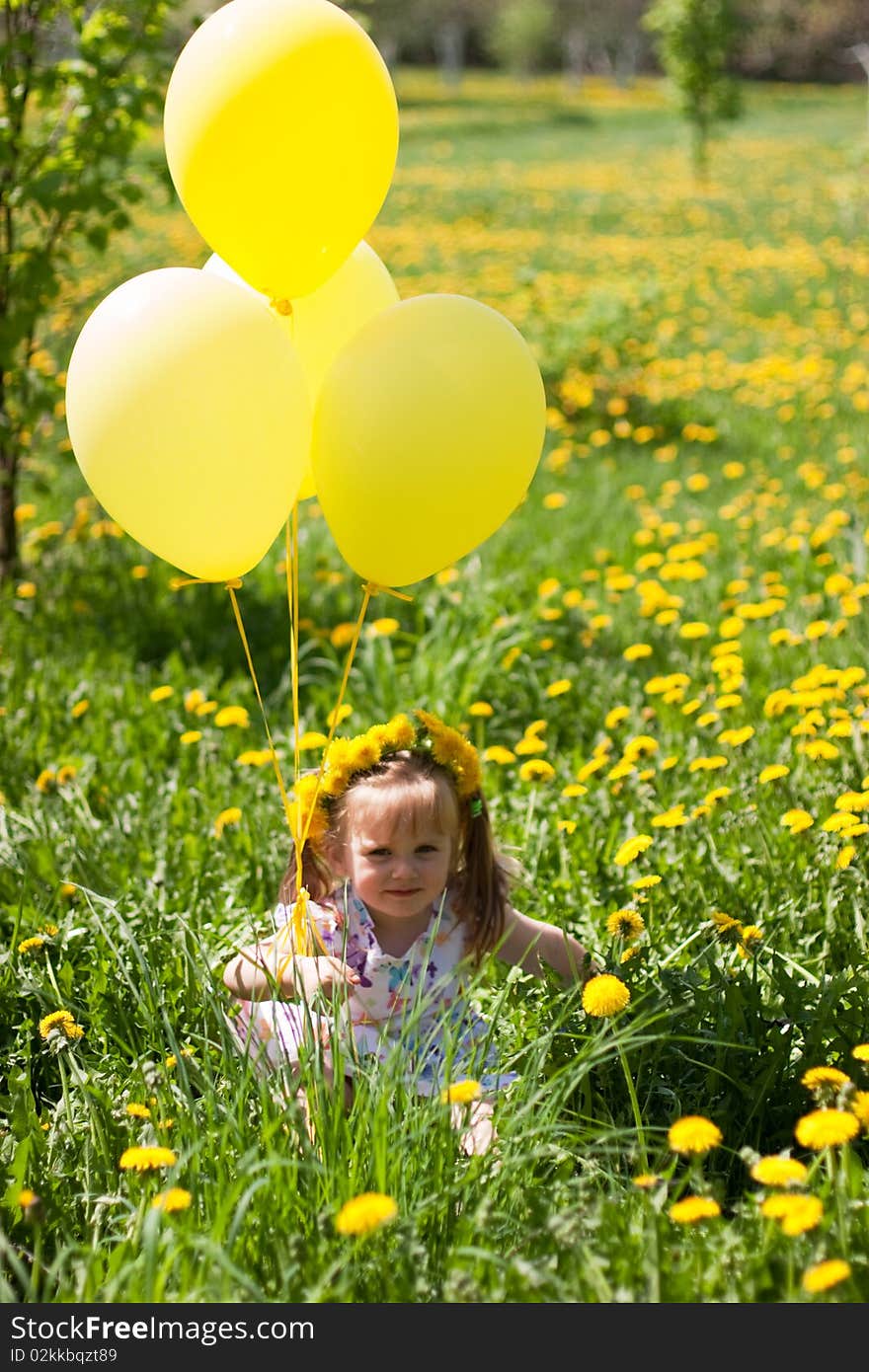 Little girl with yellow balloons on dandelion field. Little girl with yellow balloons on dandelion field