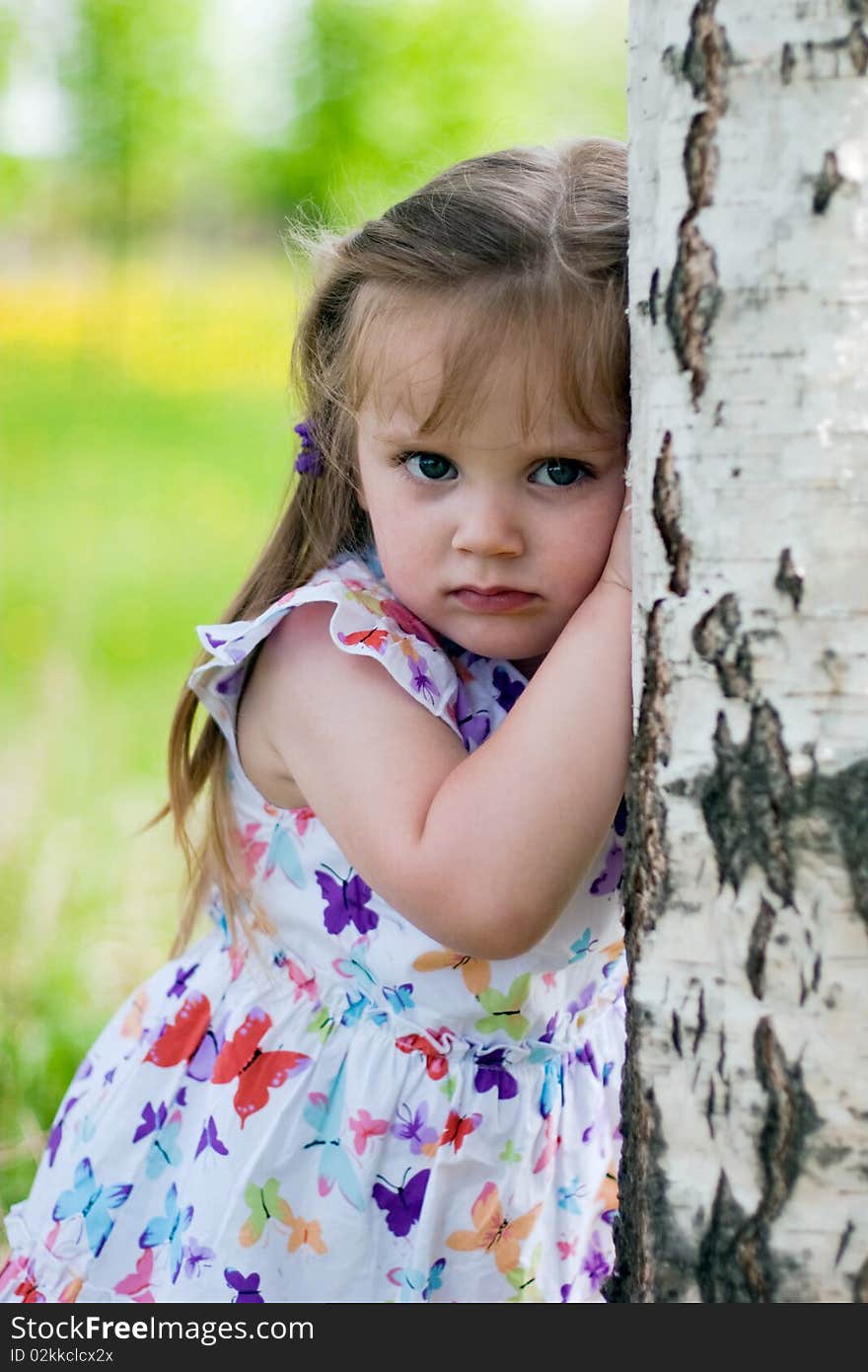 Little girl near birch