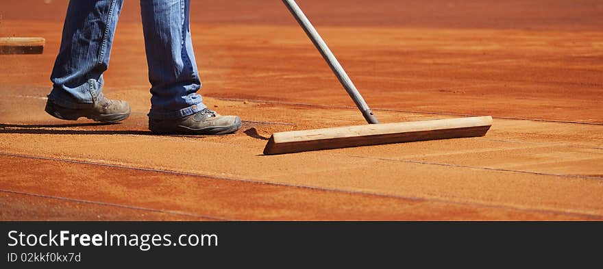 Tennis court preparation close up. Tennis court preparation close up