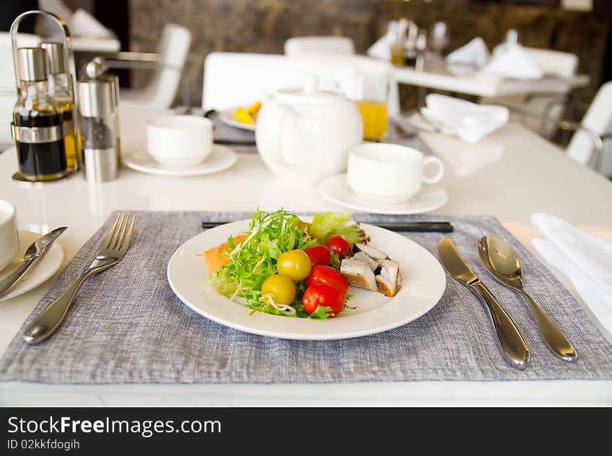 A white dish with fresh salad