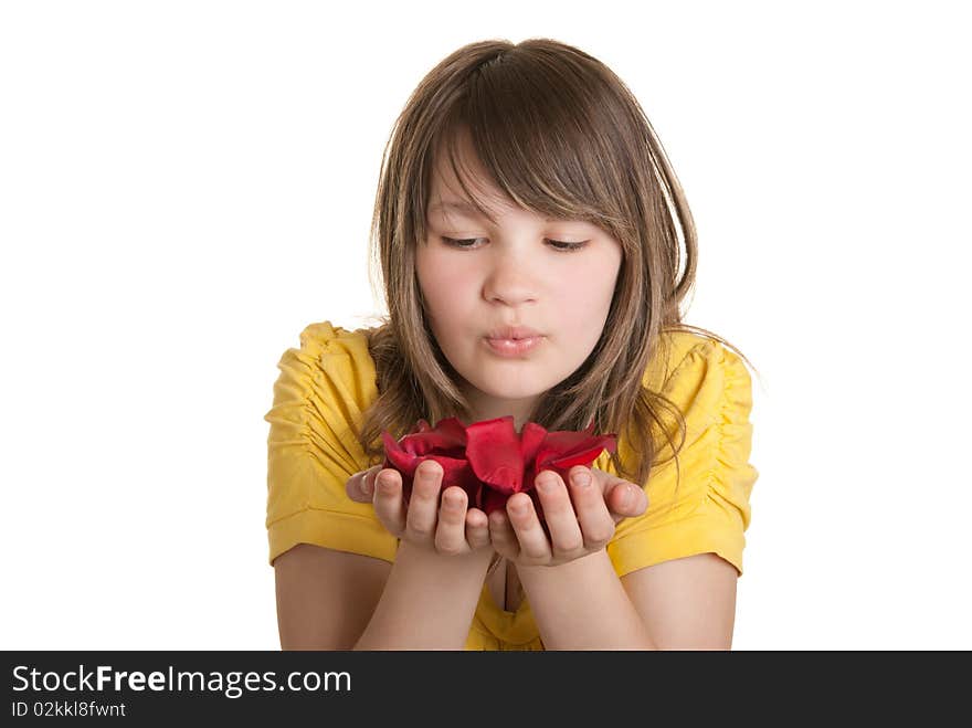 Girl blows on petals lying on palm isolated in white