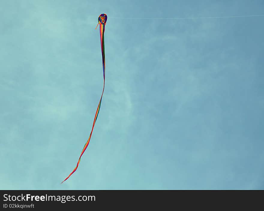 View of kite flying against a cloudy sky.