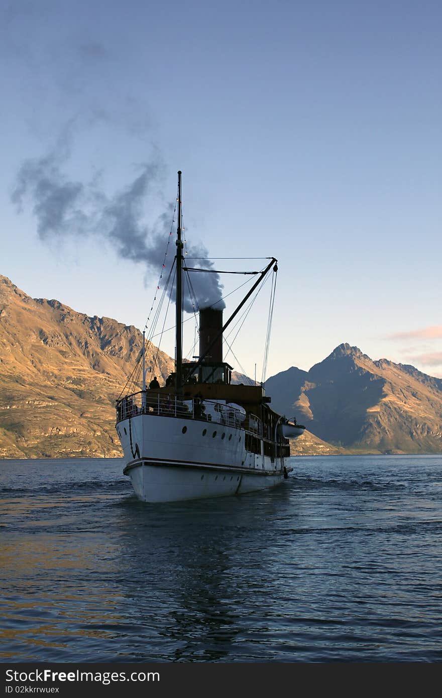 Steamboat in shadow on a lake in Queenstown, New Zealand. Steamboat in shadow on a lake in Queenstown, New Zealand