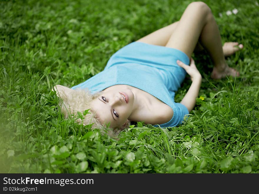 Beautiful girl lying on the grass