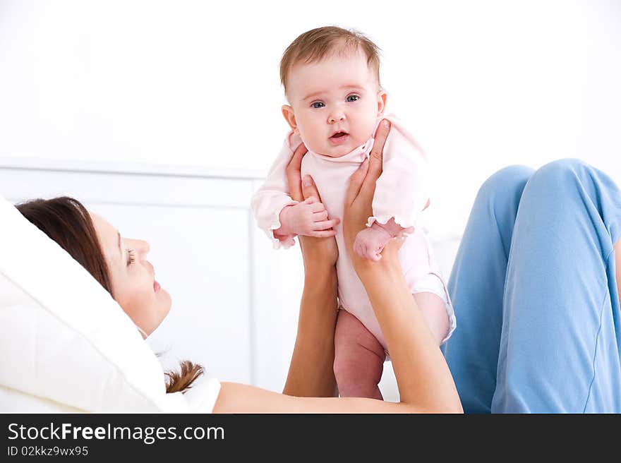 Beautiful liittle kid on the mother's hands - indoors. Beautiful liittle kid on the mother's hands - indoors