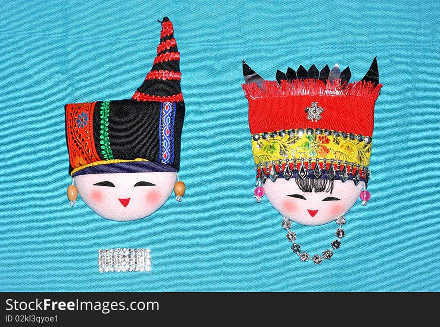 Finery embroidery doll of Chinese minority Chuang's tradtional style. The raiment and hat for men and women in feast day. Finery embroidery doll of Chinese minority Chuang's tradtional style. The raiment and hat for men and women in feast day.