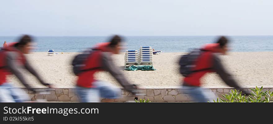 Quick movement makes blurred picture. Photograph has three phase movement of one cyclist. Quick movement makes blurred picture. Photograph has three phase movement of one cyclist.