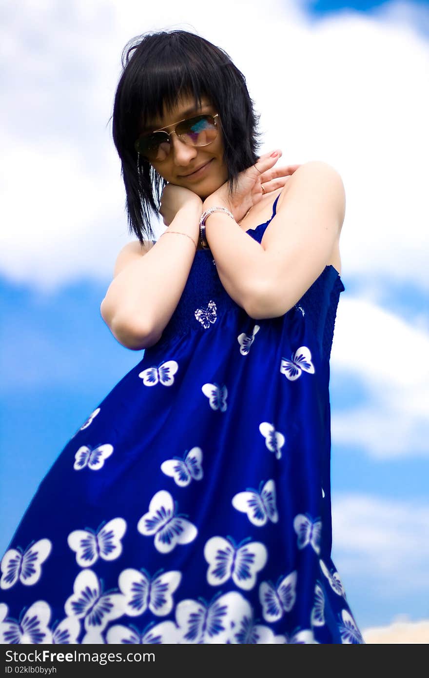 Summer girl against a background of blue sky. Summer girl against a background of blue sky