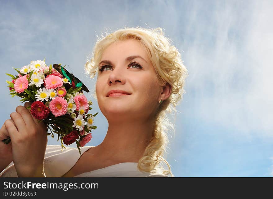 woman with a butterfly over blue sky