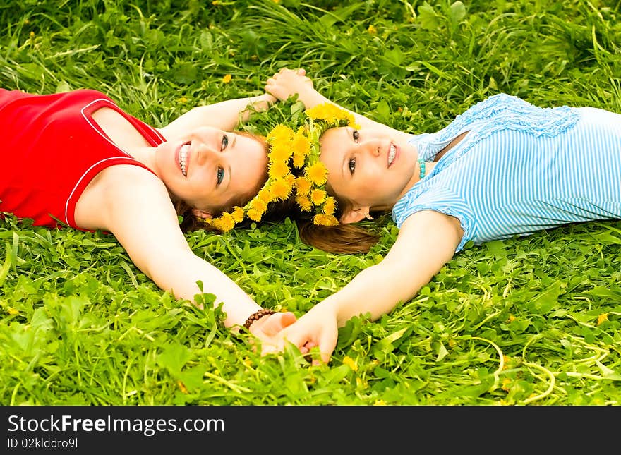 Young smiling women on the grass. Young smiling women on the grass