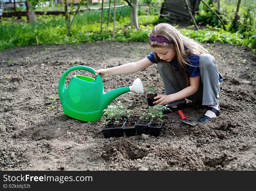 An image of a nice little girl working in the garden. An image of a nice little girl working in the garden