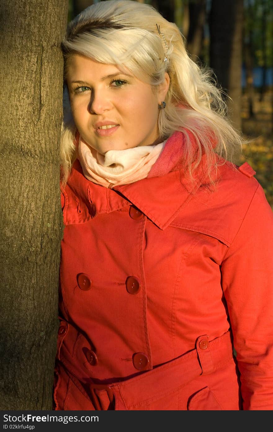 Woman in a red coat walks in autumn park. Woman in a red coat walks in autumn park