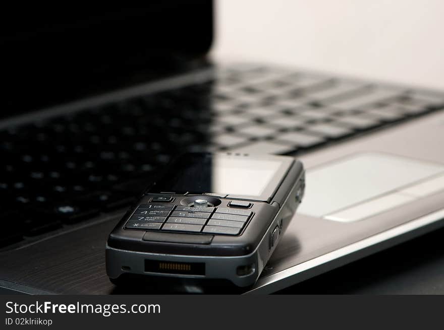 Mobile phone on a keyboard of notebook. Mobile phone on a keyboard of notebook