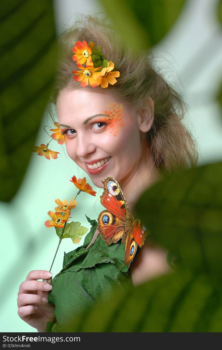 Portrait of forest nymph with butterfly on her shoulder