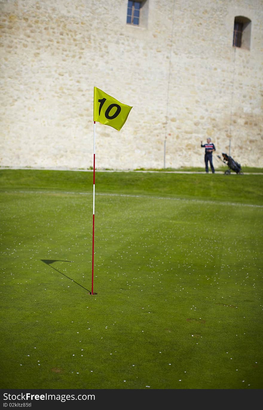 Yellow flag hole marker at the golf course