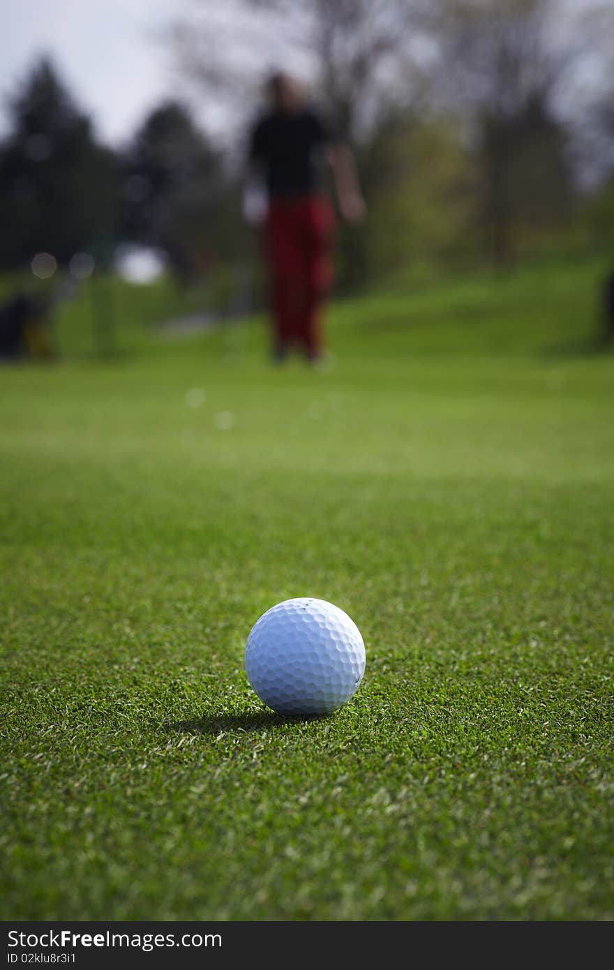 Golf ball close-up with golfer man