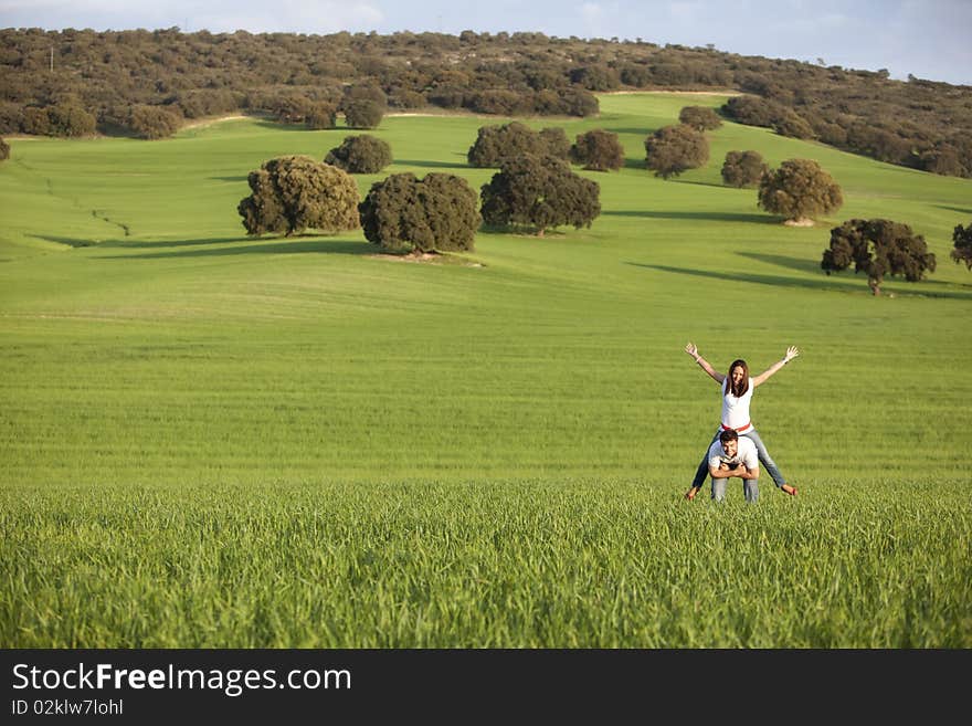 Young playful couple enjoying on nature