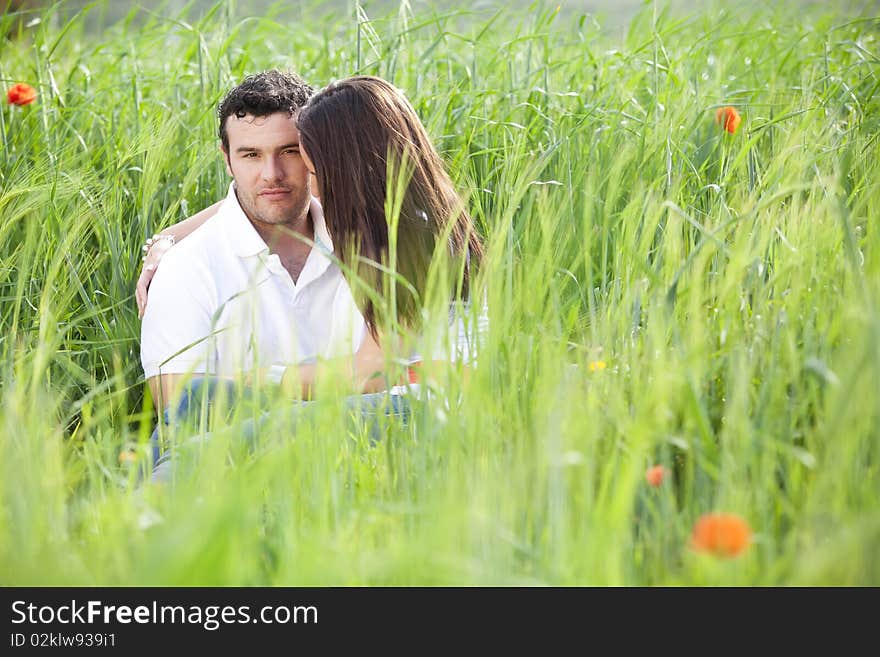 Young couple surrounded by green wheat. Young couple surrounded by green wheat.