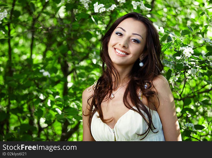 The beautiful girl in greens of trees