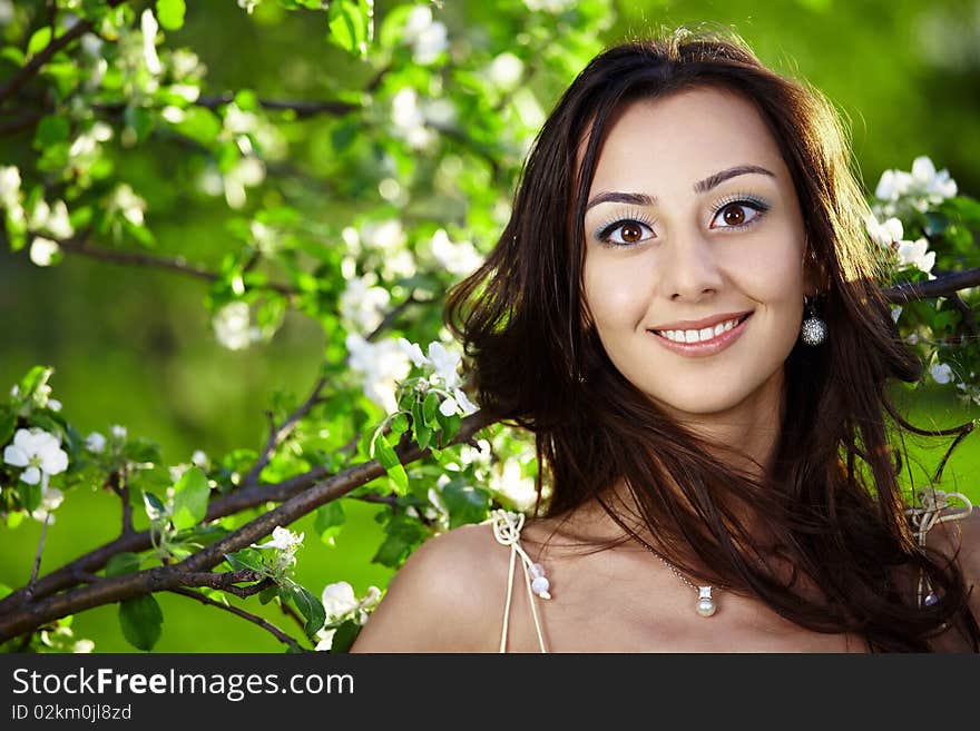 The beautiful girl in a dress against trees. The beautiful girl in a dress against trees