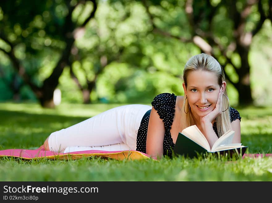 Girl with book in park