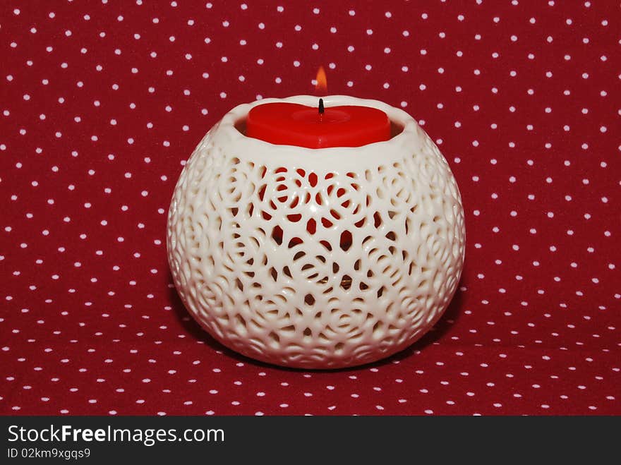 Openwork candlestick with a candle