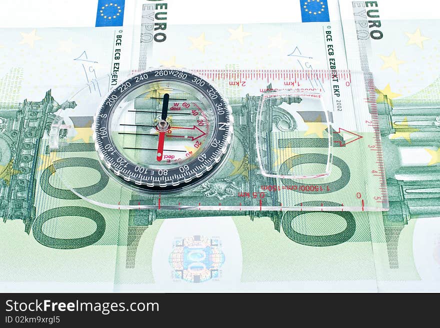 Currency euro and compass,Ñlose up. Currency euro and compass,Ñlose up