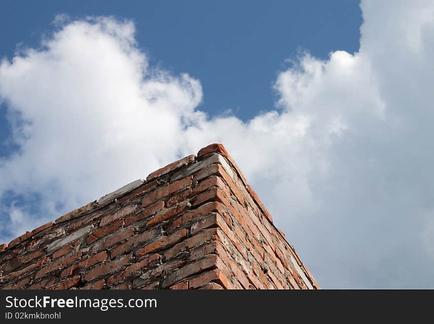 Brick wall against the blue sky