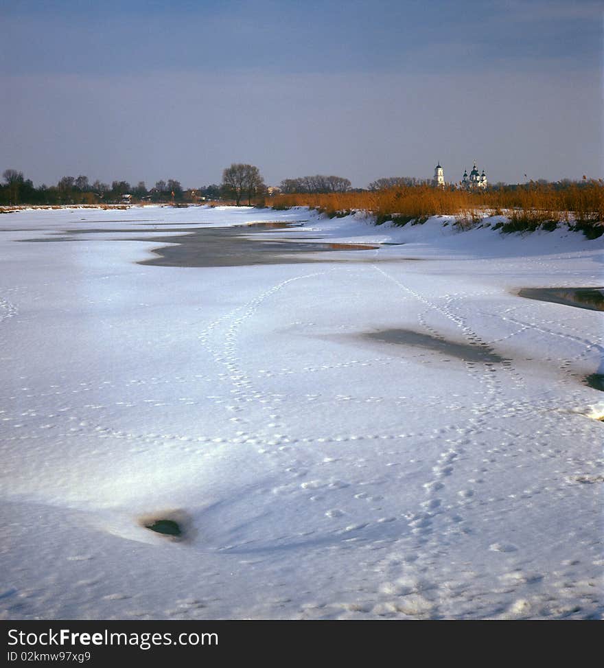 Winter landscape with frozen pond and orthodox church. Kozeletc, Ukraine. Winter landscape with frozen pond and orthodox church. Kozeletc, Ukraine.