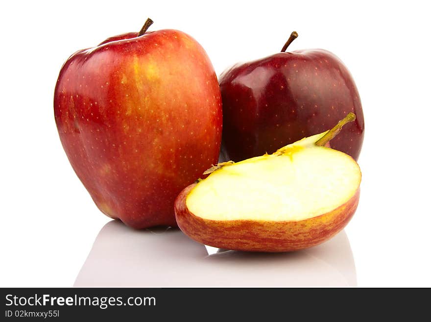 Red ripe apples on the reflecting surface