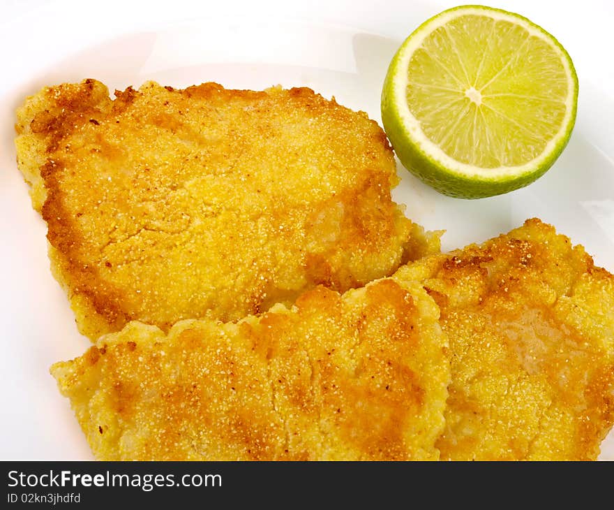 Fish Filet with lemon. Close up on white background