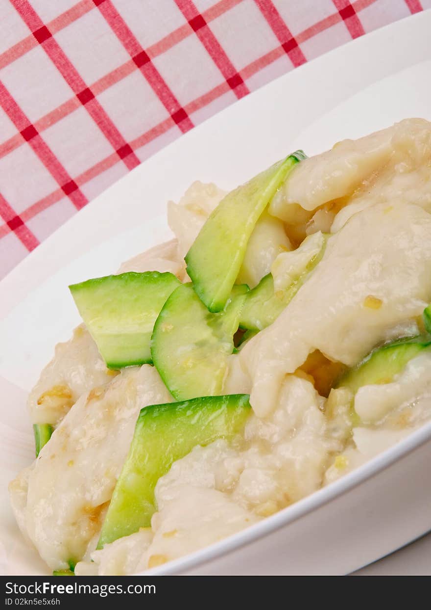 Fried white fish with cucumber. Close up