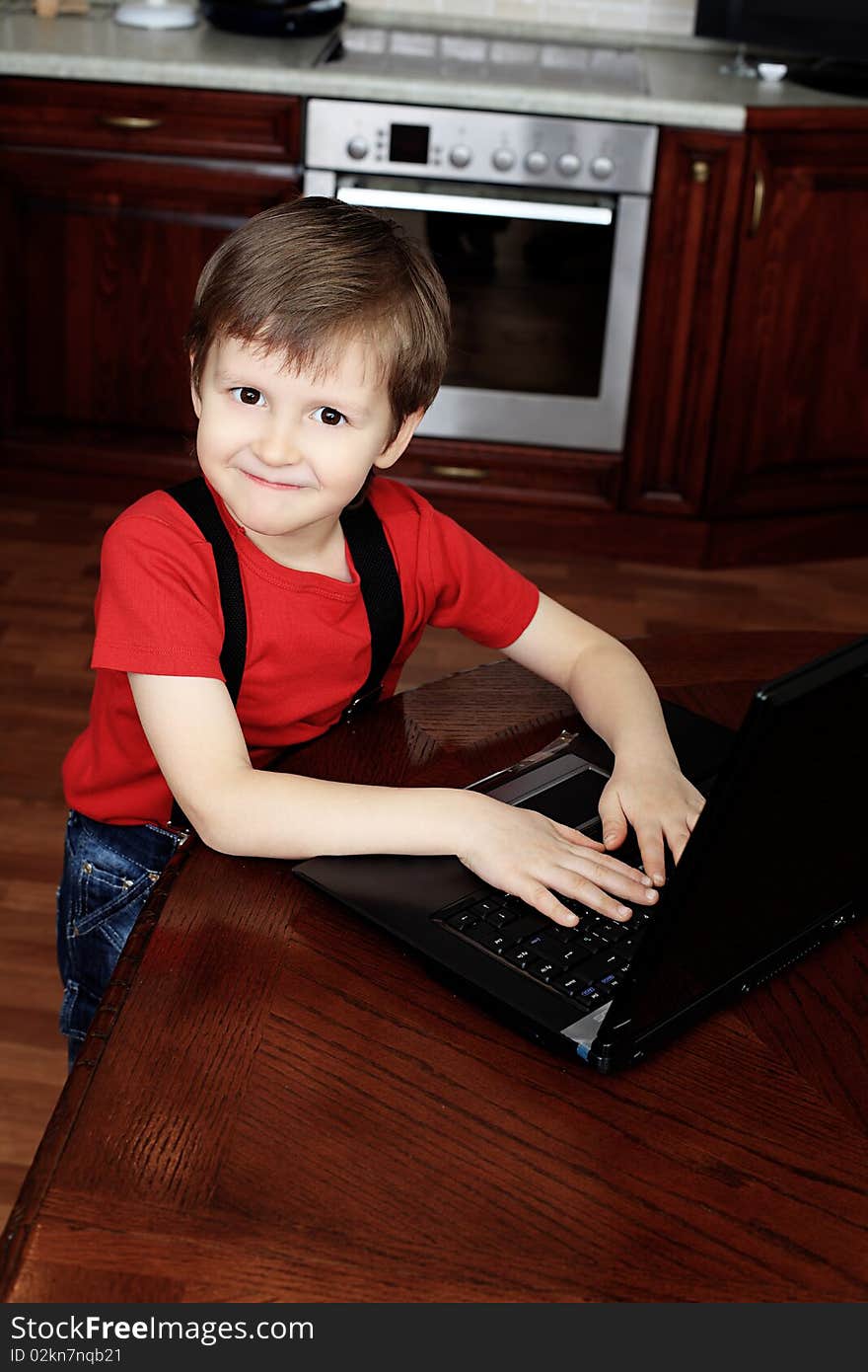 Little boy with his laptop at home. Little boy with his laptop at home.