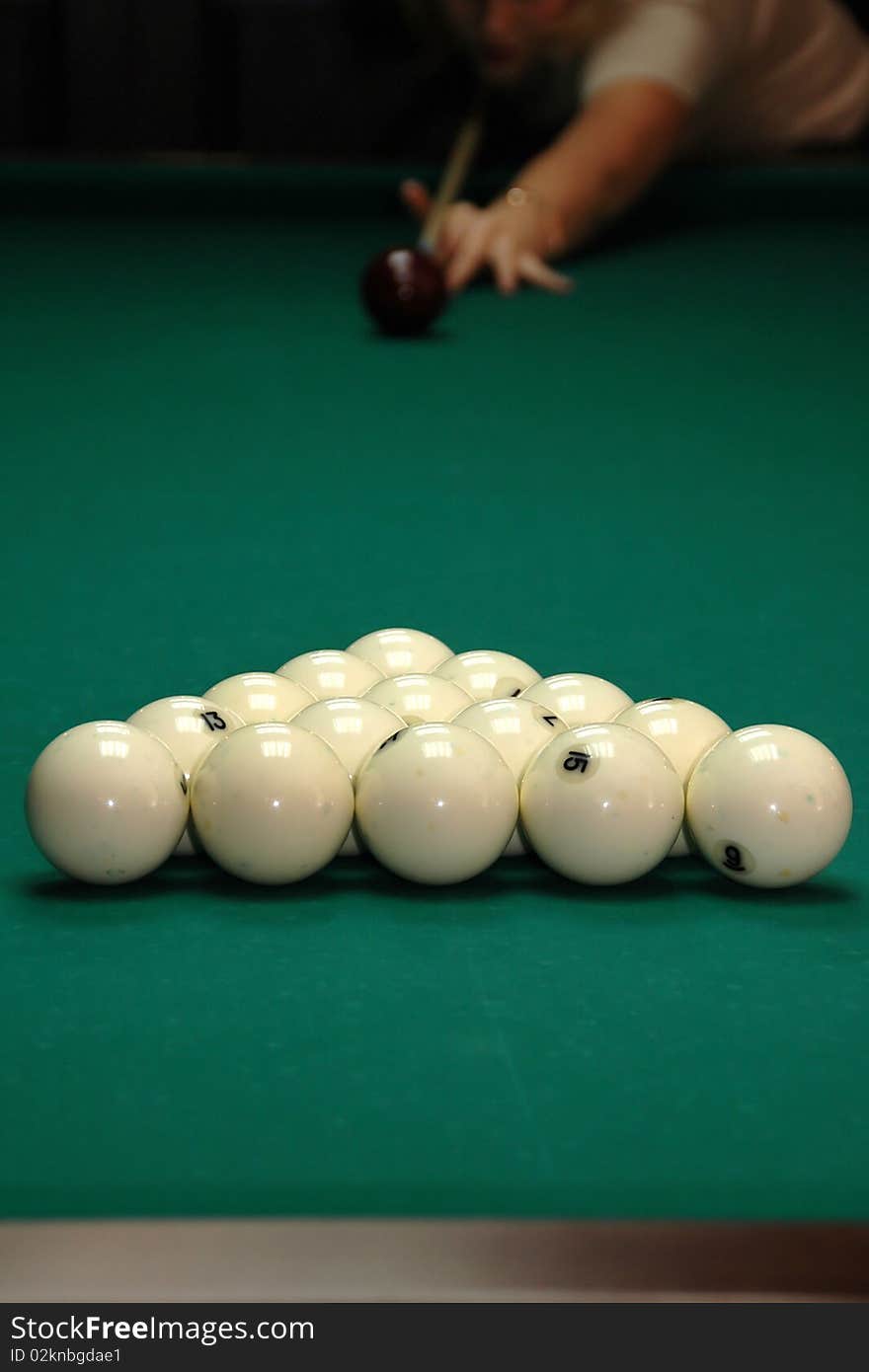 Young girl playing billiards. Competition.