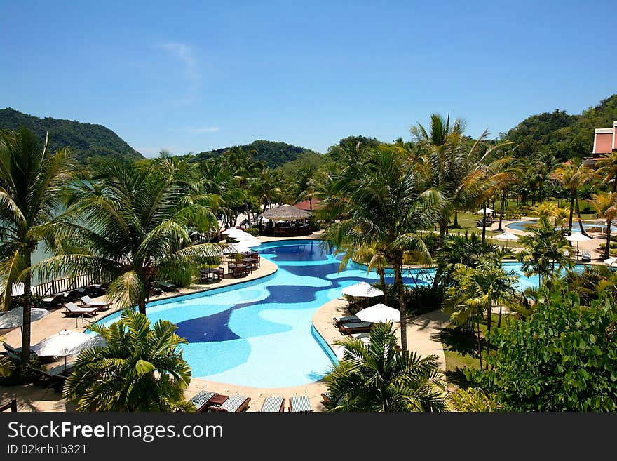 View to swimming pool and garden in tropical resort.