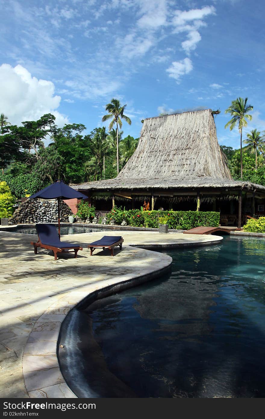 Swimming pool and thatched roof bar in tropical hotel. Swimming pool and thatched roof bar in tropical hotel