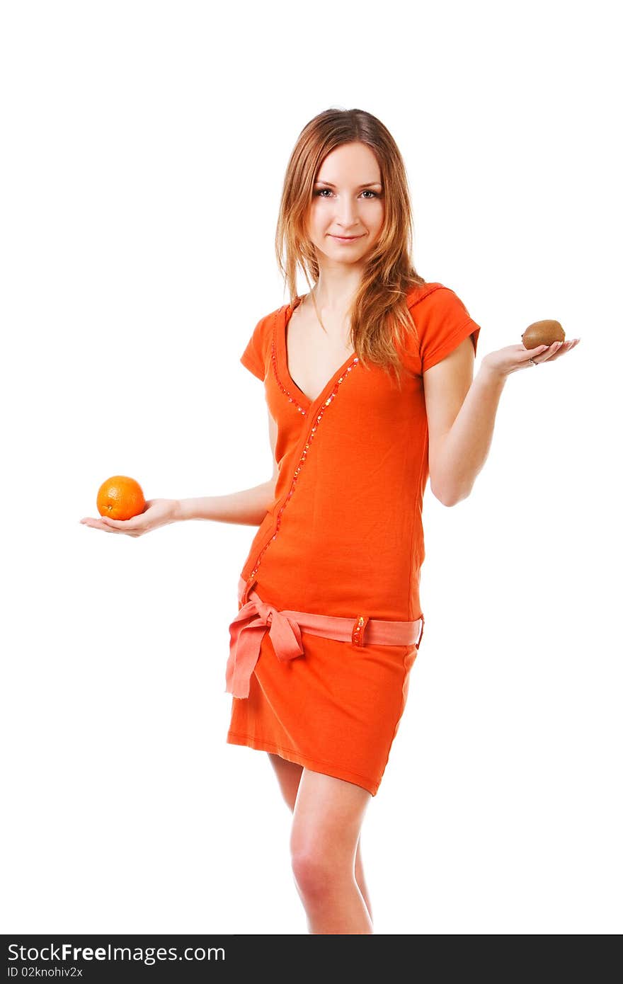 Picture of a young pretty girl in dress which holds orange and kiwi in different hands. Isolated on white. Picture of a young pretty girl in dress which holds orange and kiwi in different hands. Isolated on white.