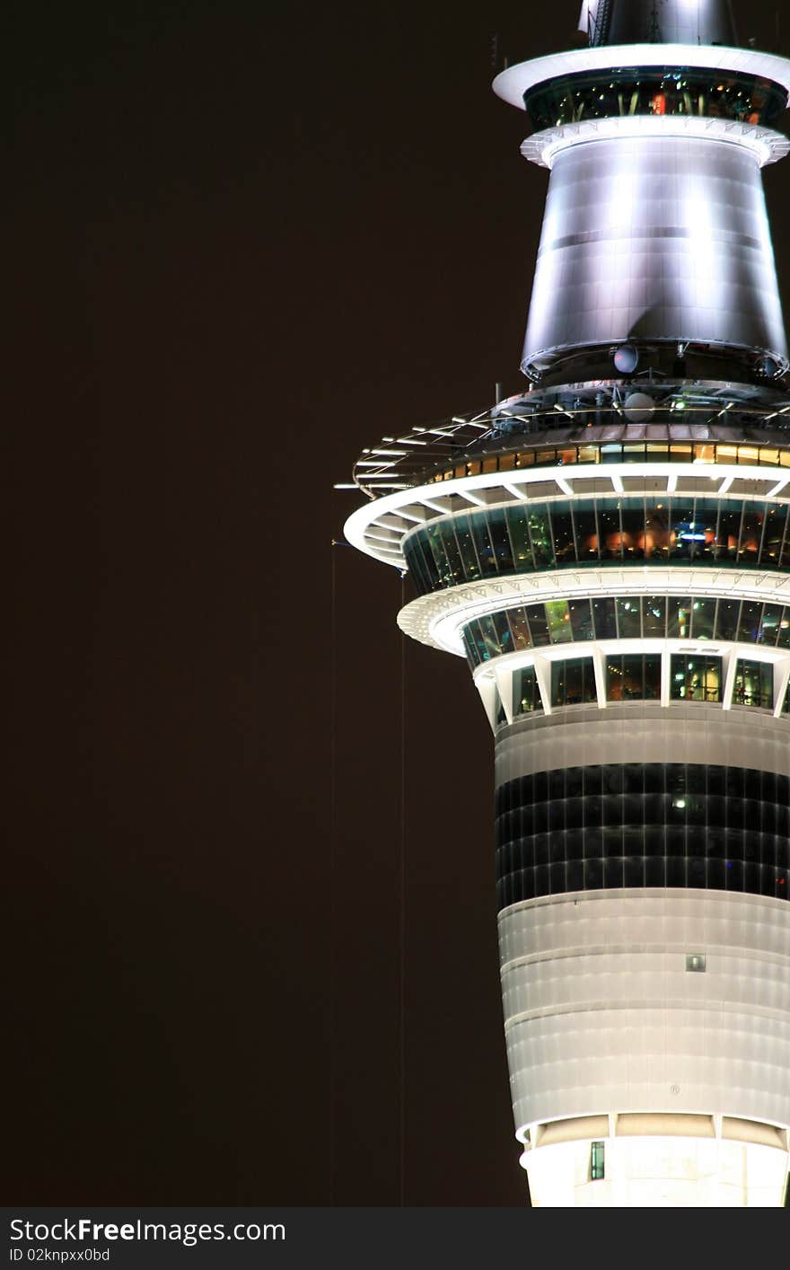 A close image of a tall city structure, taken at night. A close image of a tall city structure, taken at night