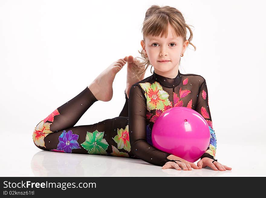 Little girl in gym clothing making exercises. Little girl in gym clothing making exercises