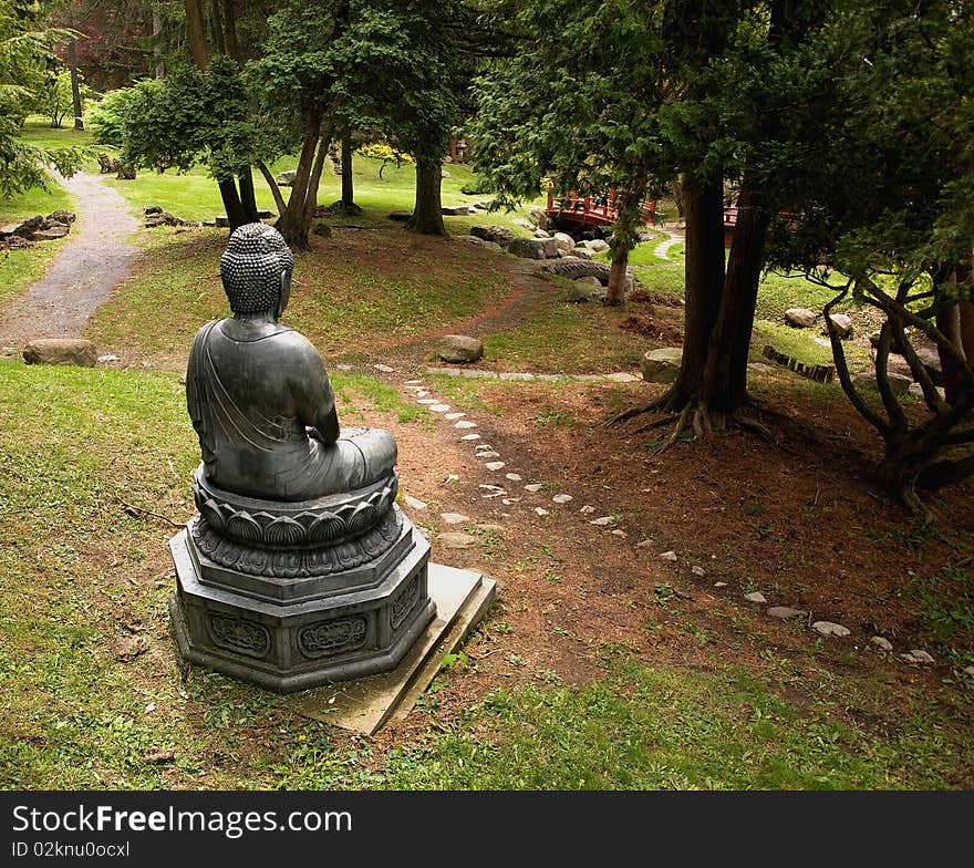 Wide angle view of a buddha statue in a park