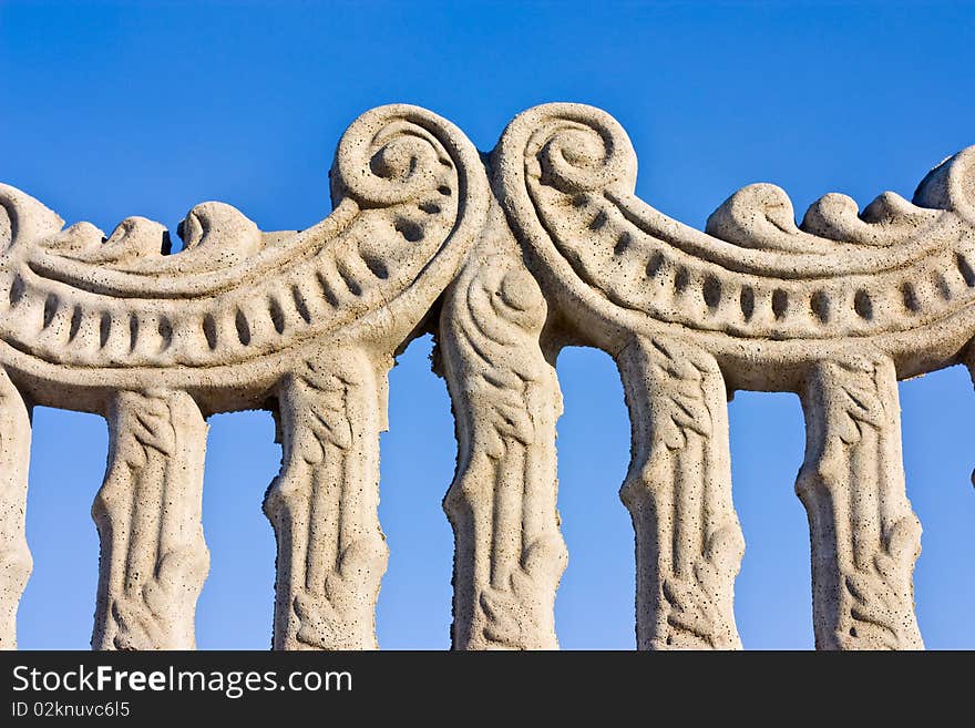 Ancient fence on a blue sky