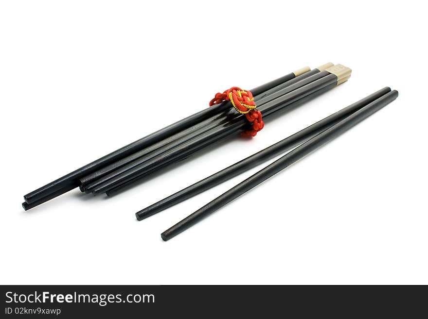 Black chopsticks on a white background